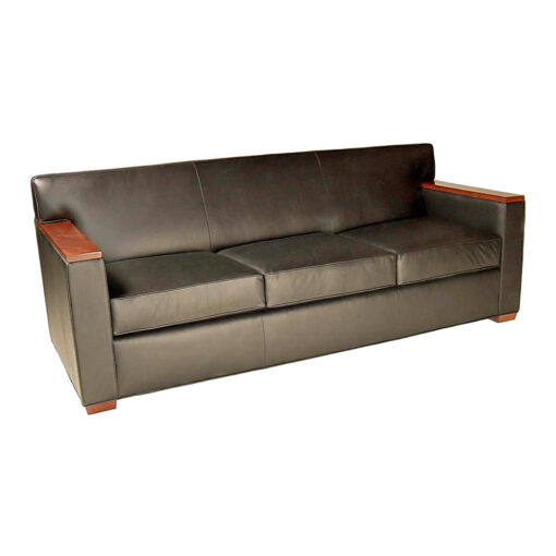 Charlie lounge sofa with wood caps on arms, steel gray leather upholstery and wooden legs.