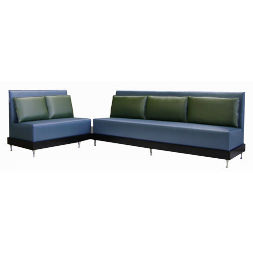 Blue upholstered banquette with green attached pillows to back; Salon Banquette