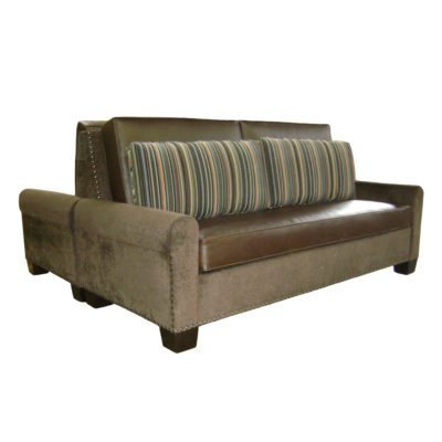 Double sided banquette with brown leather upholstered seats, fitted pillows on back with a nail head trim along outer edge; Rio Vista banquette