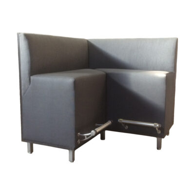 Gray upholstered Canyon Banquette with steel foot rails in front