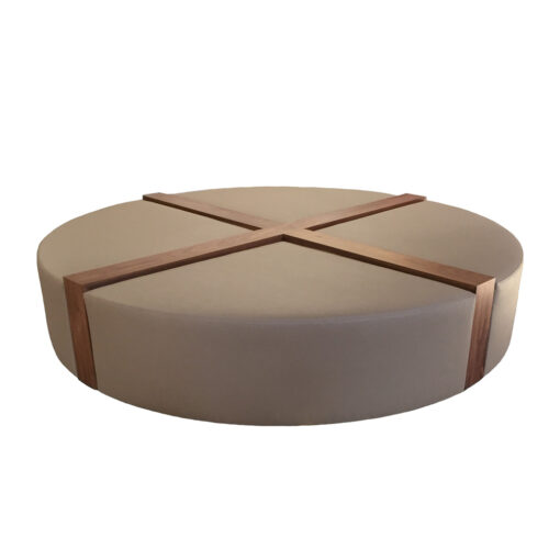 Tan upholstered circular Pampa bench cross sectioned with two inch wood paneling from center and down sides