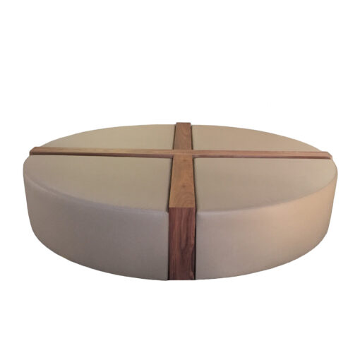 Tan upholstered circular Pampa bench cross sectioned with two inch wood paneling from center and down sides